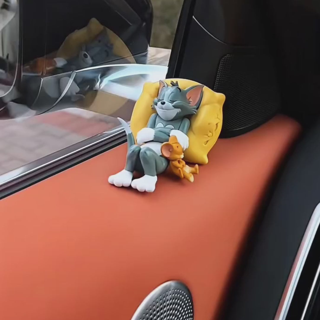 Load video: &quot;Tom cartoon character relaxing on a car seat with a cushion.&quot;